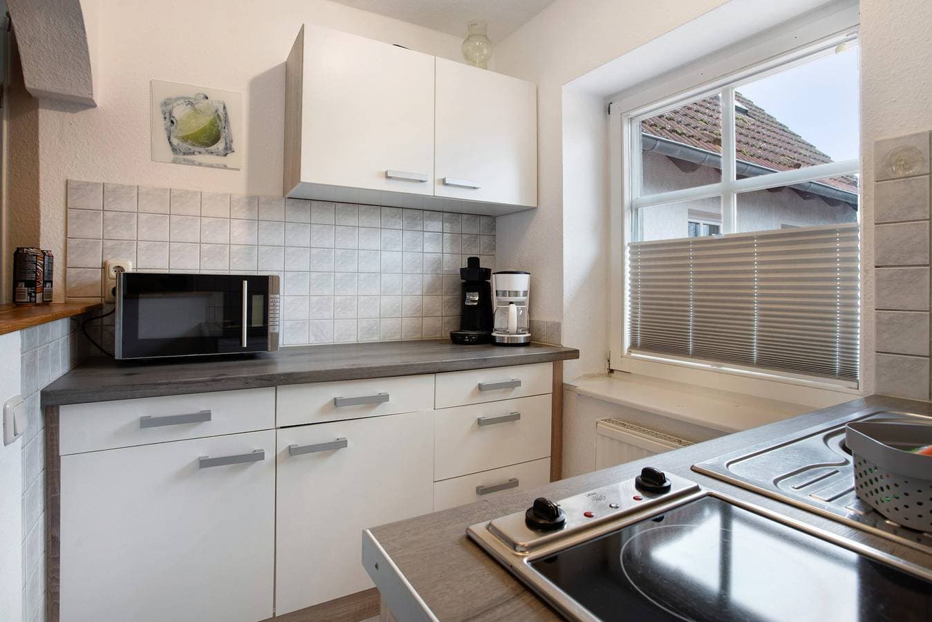 Foto 7 von 19: Einzimmerapartment 'Bäckerhus - Ferienwohnung 3' mit Gemeinschaftsterrasse und Garten
