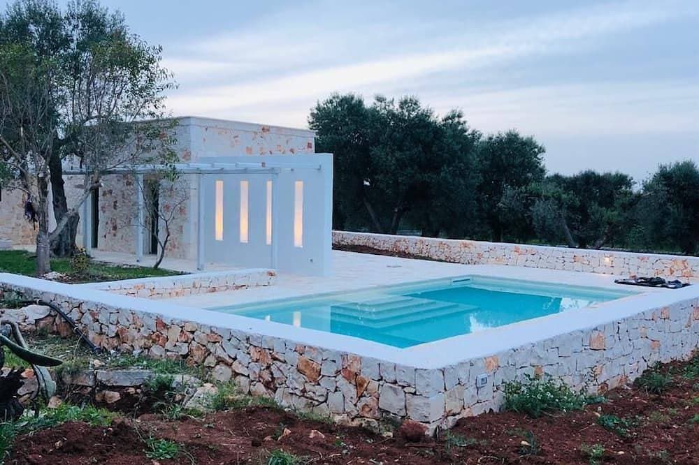White stone typical apulian villa  with barrel roof  surrounded by olive trees. 1