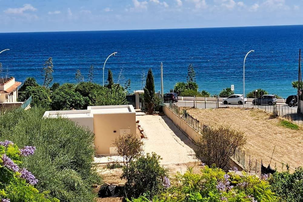 Beachfront villa with a garden and private parking on the property. 1