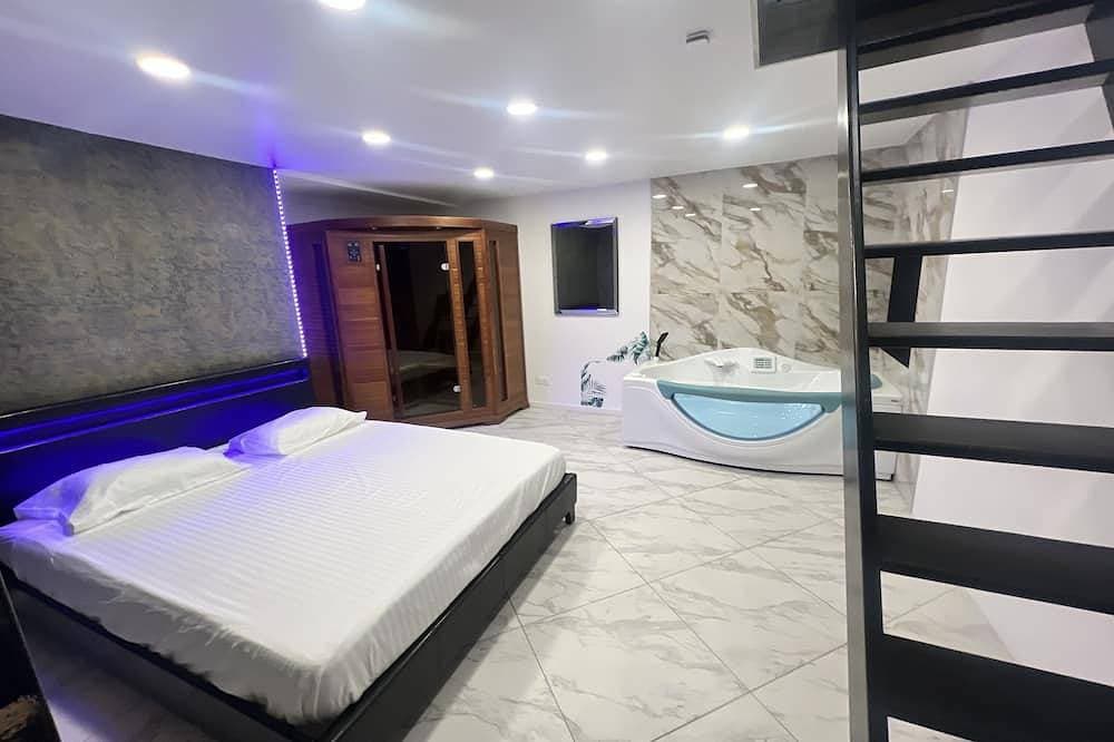Foto 2 von 13: Maison Appartement Triplex Avec Jacuzzi et Sauna